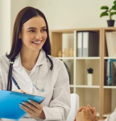Dentist with a patient discuss dental insurance verification