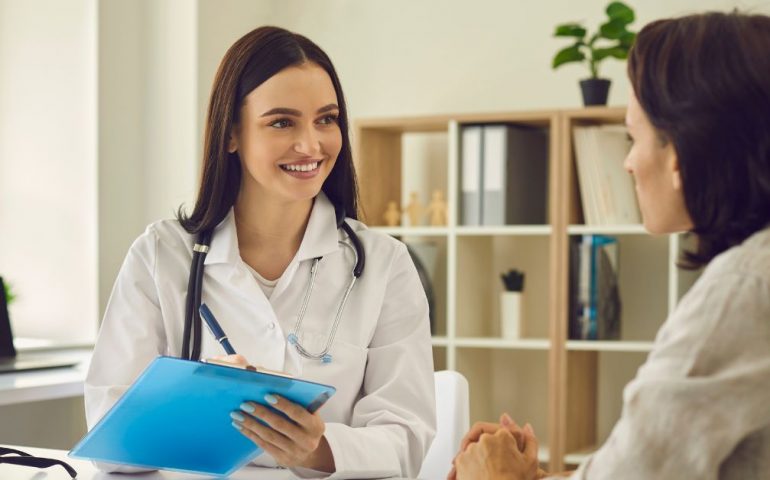 Dentist with a patient discuss dental insurance verification