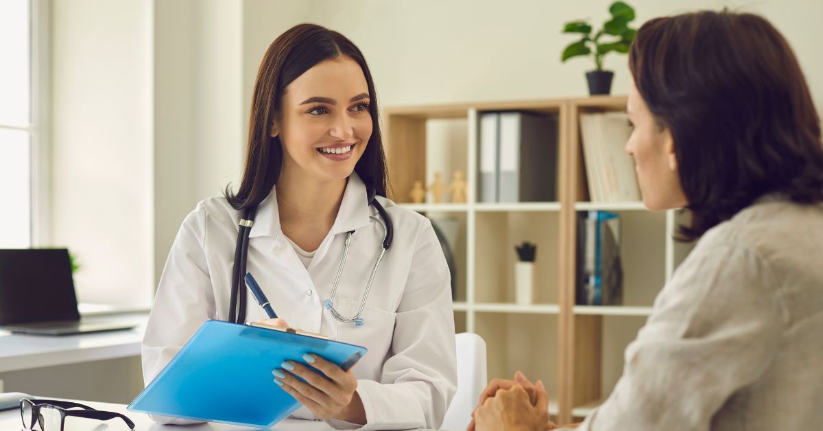 Dentist with a patient discuss dental insurance verification